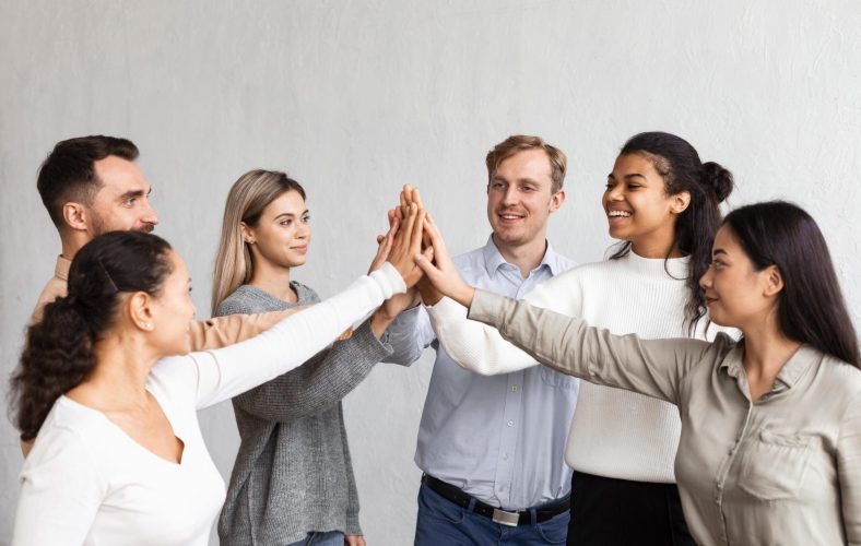 smiley-people-high-fiving-each-other-group-therapy-session